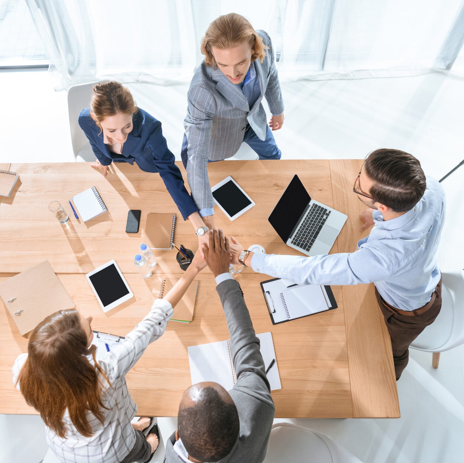VistaCreate-178961304-stock-photo-business-team-shaking-hands-table-office-space
