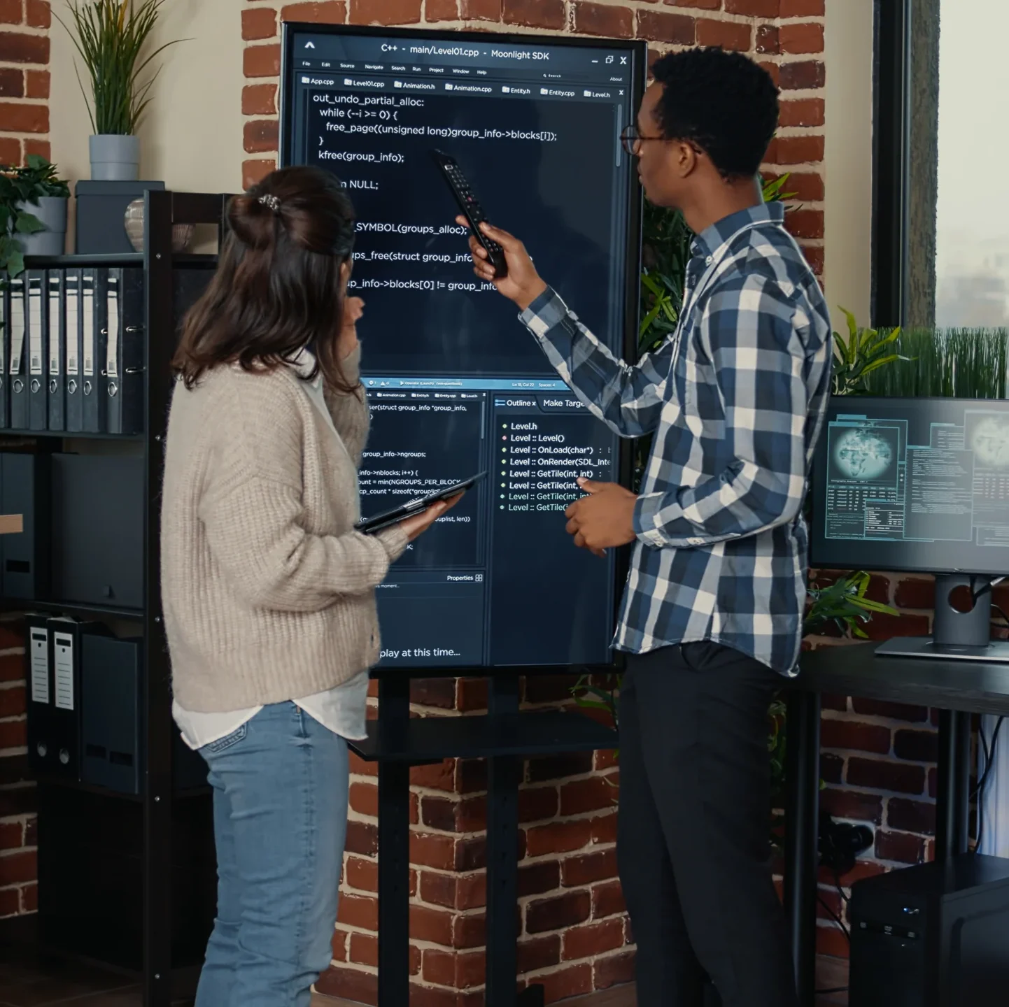 VistaCreate-574048594-stock-photo-team-database-admins-analyzing-source-code-wall-screen-comparing-errors